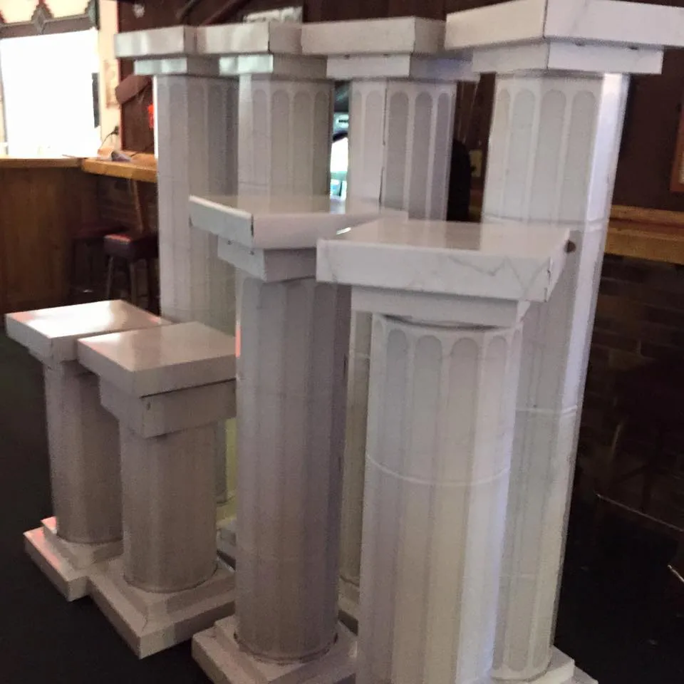Hand-built cardboard Roman columns before the event