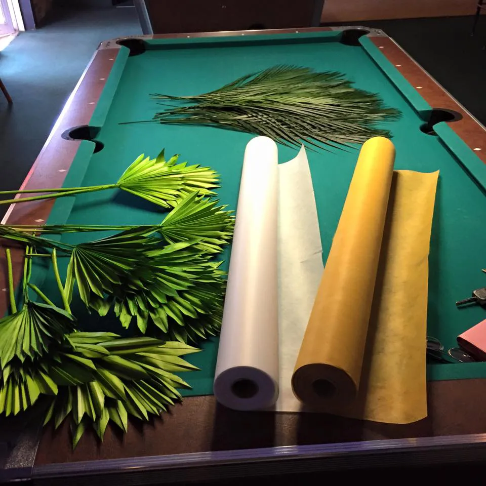Palm fronds being prepared as decor for the fundraiser
